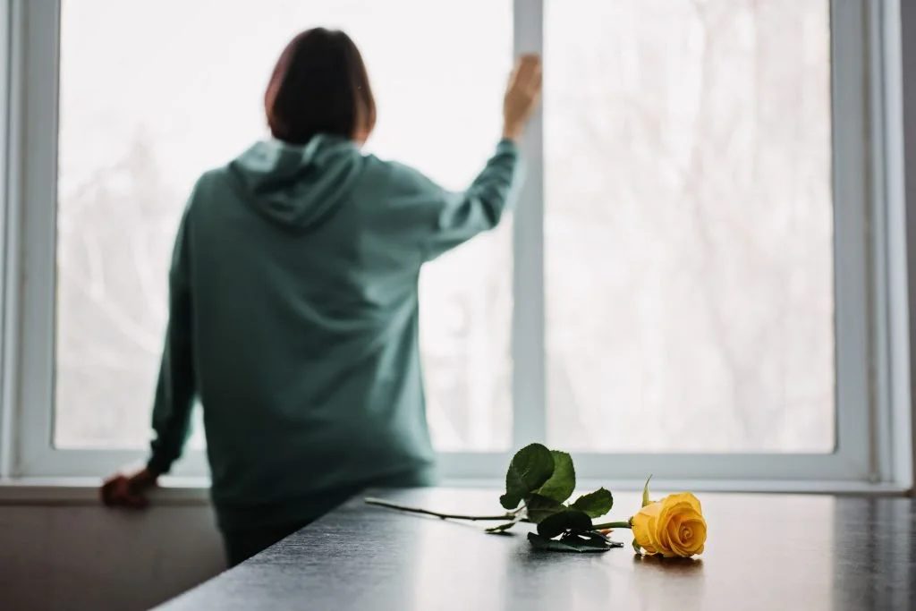 woman standing in front of a window