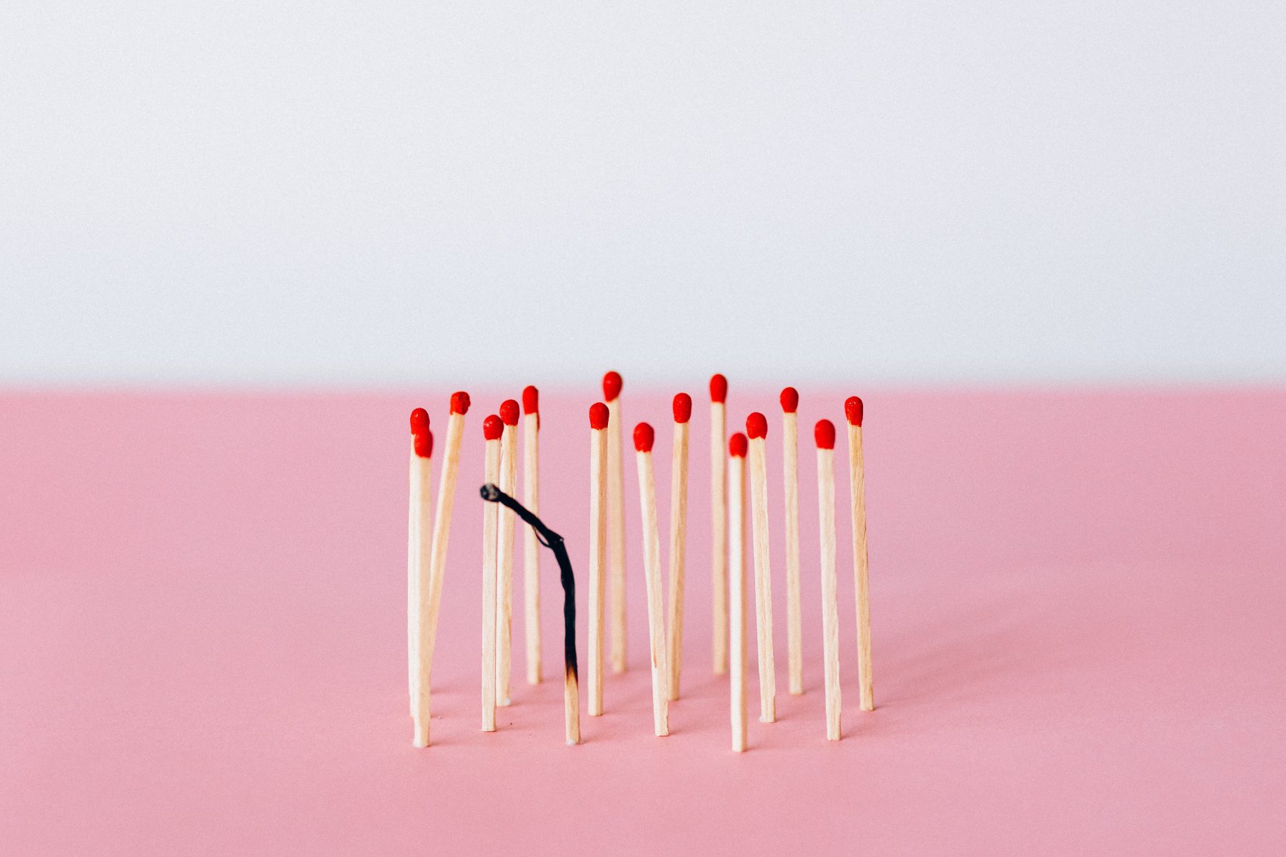 Matches lined together with only one burnt out.