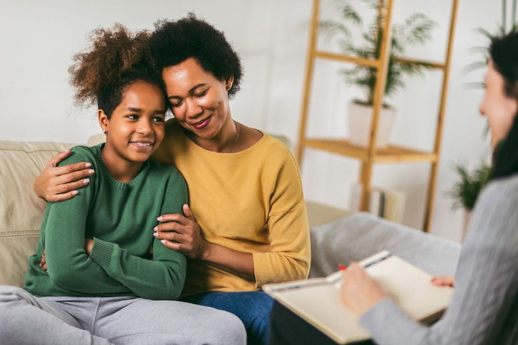 Two women hugging in a therapy session
