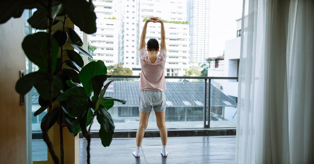 A patient stretching on the balcony. physical rehabilitation program
