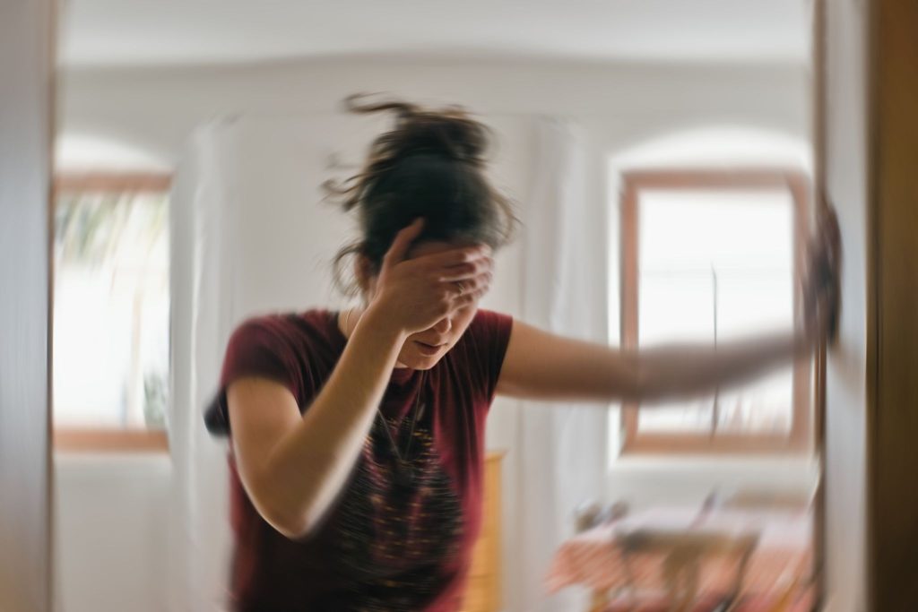Woman suffering from vertigo, most likely from stress